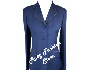 May include: A blue blazer with a gold trim around the collar and pockets. The blazer has a button closure and a single pocket on each side. The text "Ruby Fashion Store" is visible on the blazer.