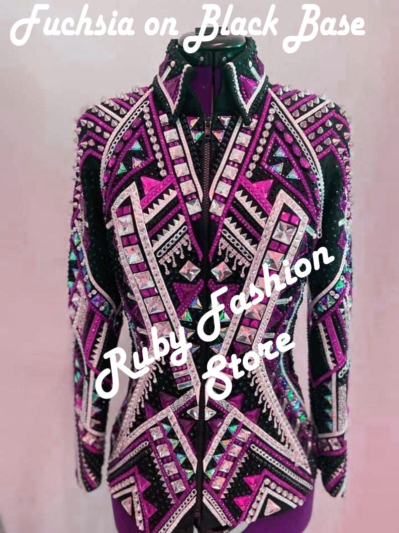 May include: A black jacket with fuchsia and white geometric patterns, featuring a front zipper, a high collar, and extensive embellishments of silver studs and clear crystals. The text "Fuchsia on Black Base" and "Ruby Fashion Store" is visible.