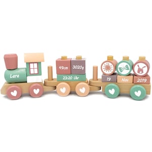 Peut inclure: Un train en bois jouet avec des blocs colorés présentant les détails de naissance d'un bébé. Les blocs comprennent le nom du bébé "Lara", la date de naissance "19 novembre 2019", l'heure "23:20 Uhr", la longueur "49 cm" et le poids "3020 g".