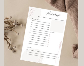 Peut inclure: Un modèle de recette imprimable avec un fond blanc et un motif floral rose et brun clair. Le modèle comporte des sections pour les ingrédients, les instructions et les notes. Le texte "Mein Rezept" est écrit en cursive en haut de la page.