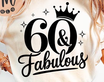 May include: Cream-colored t-shirt with the text "60 & Fabulous" in black script, a crown, and star accents. The shirt is paired with blue jeans. The image includes a logo in the upper left corner.