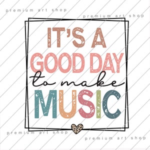 May include: A colorful graphic design with the text "IT'S A GOOD DAY to make MUSIC" in a distressed font. A small leopard print heart is at the bottom of the design.