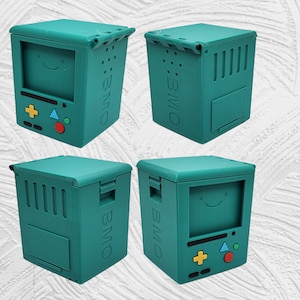 May include: Four teal blue 3D printed boxes with the text "BMO" on the side. Each box has a different design on the front, including a smiley face, a game controller, and a blank panel.