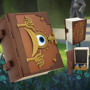May include: A brown, book-shaped container with gold accents and a large blue eye design on the cover. The container is open, revealing a compartment. Additional book-shaped objects are also visible.