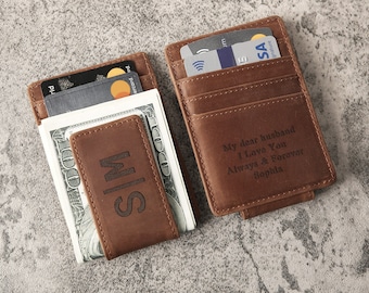 May include: Two brown leather wallets with money clips. One wallet has the initials "SIM" engraved on the front. The other wallet has the text "My dear husband I Love You Always & Forever Sophia" engraved on the front.