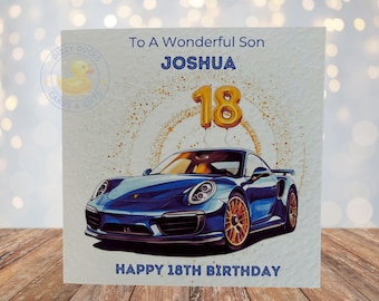 May include: A birthday card with a blue sports car and gold balloons that say "18". The card says "To A Wonderful Son Joshua Happy 18th Birthday".