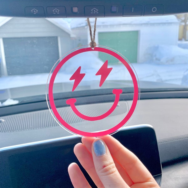 Rearview mirror smiley face hanging. Lightening bolt eyes smiley face.