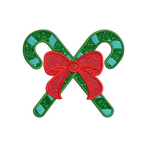 Può includere: Due bastoncini di zucchero verde e blu incrociati con un fiocco rosso al centro.
