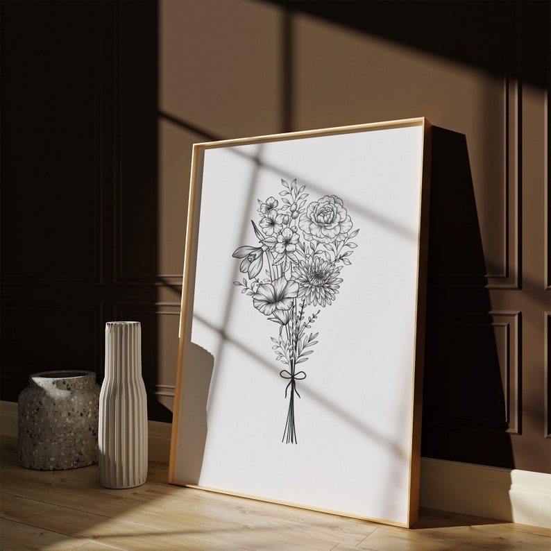 May include: A black and white line drawing of a bouquet of flowers in a simple frame. The flowers are arranged in a loose, natural style and include roses, daisies, and other blooms.
