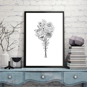May include: A black and white line drawing of a bouquet of flowers in a black frame. The flowers are tied together with a ribbon. The frame is hanging on a white brick wall.