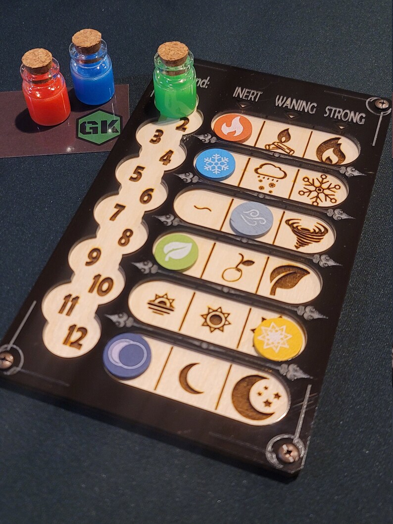 May include: A tabletop game component featuring a black board with wooden inlays and three small glass bottles with cork stoppers. The bottles contain red, blue, and green liquids. The board has numbered slots and elemental symbols.
