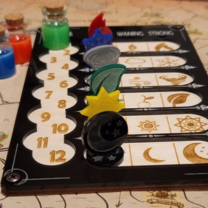 May include: A board game with a black frame and wooden accents. The board features numbered slots and symbols. Colorful potion bottles and game pieces, including a sun, moon, and leaf, are placed on the board. The text "WANING STRONG" is visible.