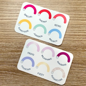 May include: Two white rectangular cards with colorful semi-circles and text. The cards feature the words "Special," "Cherry," "Retro," "Sunnyside," "Jukebox," "Brunch," "Froyo," "Milkshake," "Rhubarb," "Fizzy," "Sugar Cube," and "Fountain."