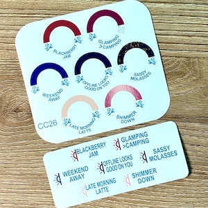 May include: A sticker sheet labeled CC26 featuring seven circular stickers with colored arches and text including Blackberry Jam, Glamping > Camping, Weekend Away, Offline Looks Good On You, Sassy Molasses, Late Morning Latte, and Shimmer Down, plus smaller matching labels.