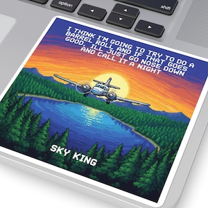 May include: A square sticker with a pixelated design of a lake, trees, and a plane against a sunset. The text reads, "I think I'm going to try to do a barrel roll and if that goes good, I'll just go nose down and call it a night." The sticker says "SKY KING".
