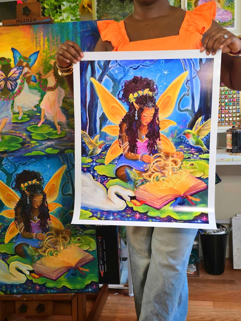 May include: A vibrant print of a fairy reading a book in a magical forest setting. The fairy has large orange wings and is surrounded by hummingbirds, a swan, and a frog. The artwork is rich in color, with blues, greens, and yellows dominating the scene.