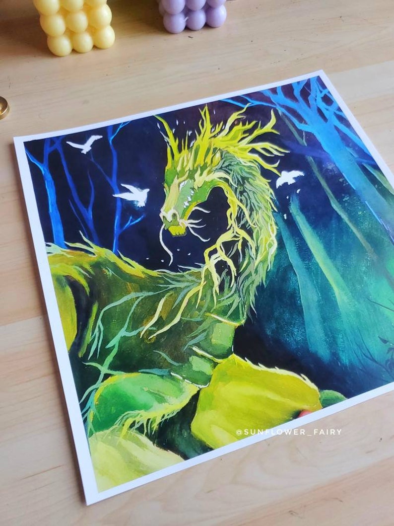 May include: A vibrant painting of a green dragon with yellow accents, set against a dark blue and green forest background. White birds are scattered throughout the scene. The artwork is signed "@SUNFLOWER_FAIRY".