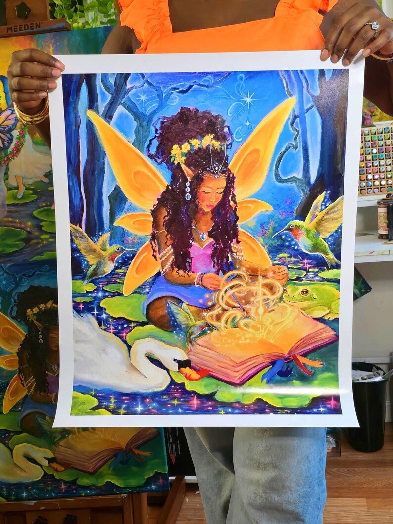 May include: A vibrant fantasy art print featuring a fairy with orange wings, sitting on a lily pad. The fairy is surrounded by hummingbirds, a swan, and a frog. An open book glows with light. The artwork is set against a blue and green background.
