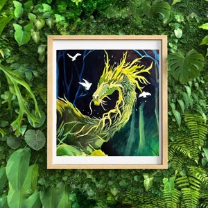 May include: A framed artwork featuring a green and yellow dragon in a forest setting. The dragon has a long, flowing body and is surrounded by white birds. The background is dark with blue trees, and the frame is a light wood color.