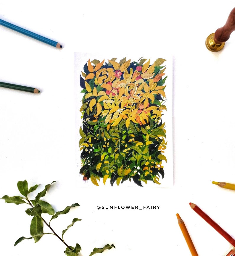 May include: A watercolor painting of a bush with yellow and green leaves. The painting is surrounded by colored pencils, a sprig of leaves, and a wax seal. The text "@SUNFLOWER_FAIRY" is at the bottom of the painting.