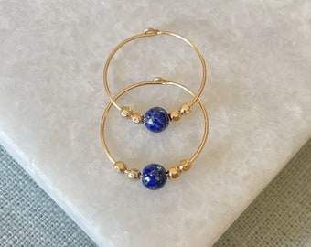 Lapis lazuli hoop earrings in gold and silver.