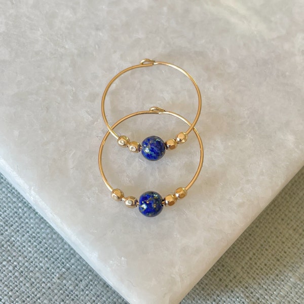 Lapis lazuli hoop earrings in gold and silver.