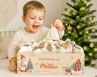 May include: A wooden Advent calendar box filled with small fabric bags, each with a wooden number tag. The box is decorated with illustrations of Santa Claus, a Christmas tree, and a bear. The text on the box reads "Adventskalender von Mattheo."