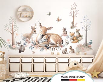 May include: A set of wall decals featuring a mother deer and fawn, along with other woodland creatures like foxes, squirrels, and birds. The decals are in shades of brown, beige, and pink, and are set against a white background. The decals are perfect for adding a touch of nature to a child's room.