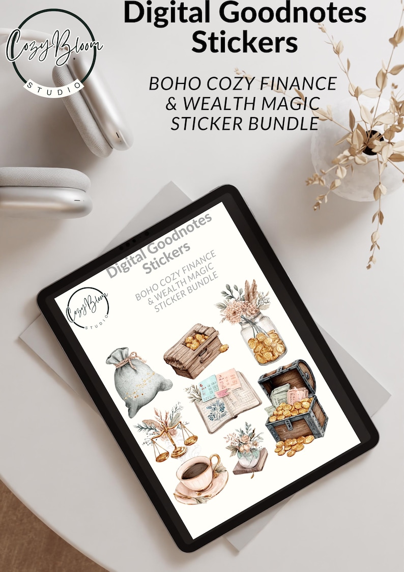 May include: A digital tablet displays a collection of digital stickers with a boho theme. The stickers include illustrations of a money bag, treasure chests, scales, a coffee cup, and a jar filled with coins. The text on the screen reads "Digital Goodnotes Stickers".