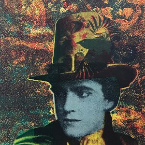 May include: A person wearing a black hat with a colorful design and a green jacket. The background is a dark green and orange speckled pattern.