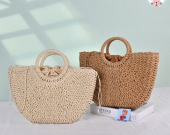 May include: Two straw tote bags with round handles. The bag on the left is light beige and the bag on the right is brown.