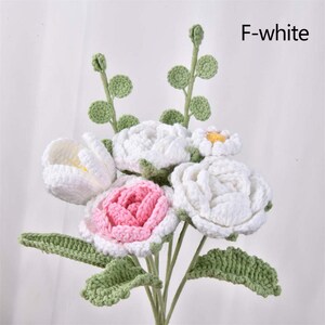 May include: A bouquet of crocheted flowers in white and pink with green leaves. The flowers are arranged in a vase and the text "F-white" is visible in the upper right corner of the image.