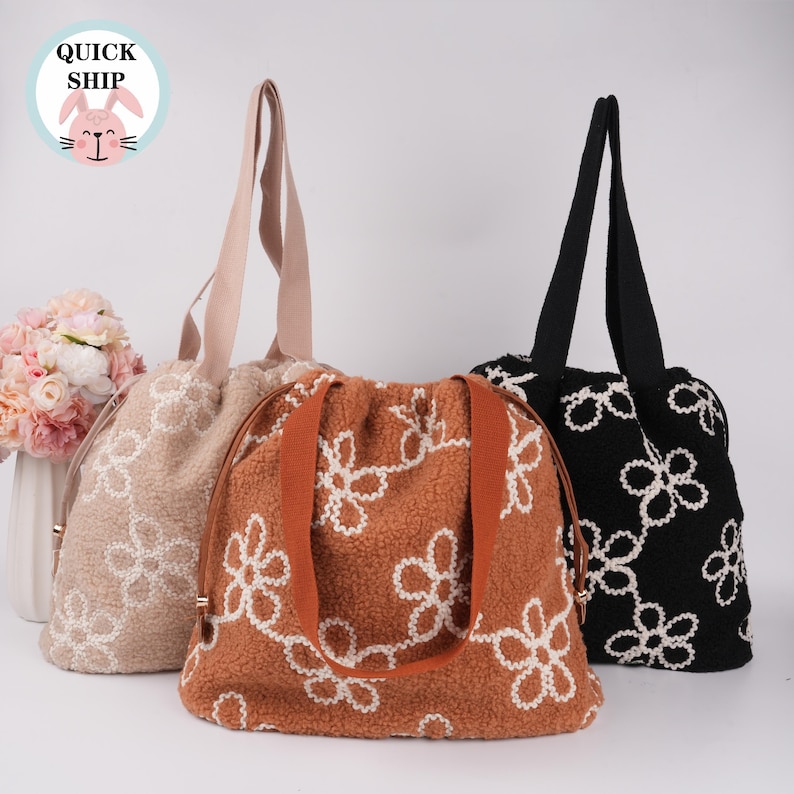 May include: Three tote bags with different floral patterns. The bags are made of a soft, fuzzy material and have a drawstring closure. The bags are in beige, brown, and black.