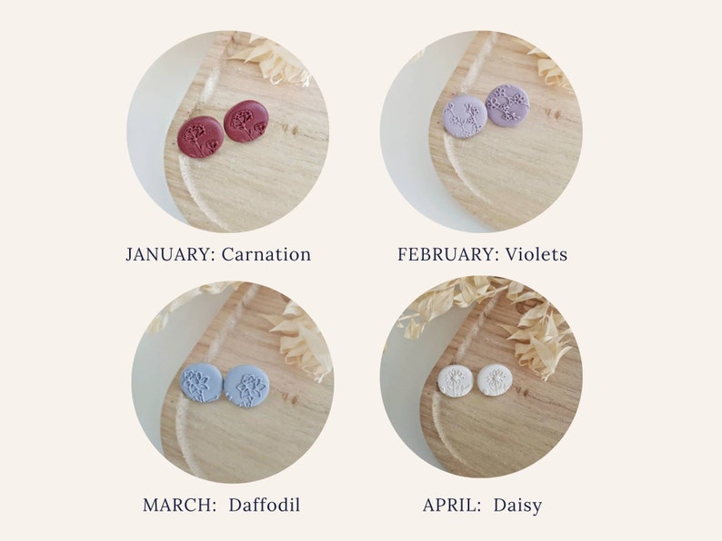 May include: Four pairs of small, round, stud earrings with floral designs. The earrings are displayed on a wooden surface. The colors of the earrings are burgundy, lavender, light blue, and white. The text below each pair of earrings reads "JANUARY: Carnation", "FEBRUARY: Violets", "MARCH: Daffodil", and "APRIL: Daisy".
