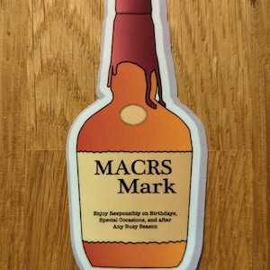 May include: A sticker of a cartoon bottle of liquor with the text "MACRS Mark" and the tagline "Enjoy Responsibly on Birthdays, Special Occasions, and after Any Busy Season".