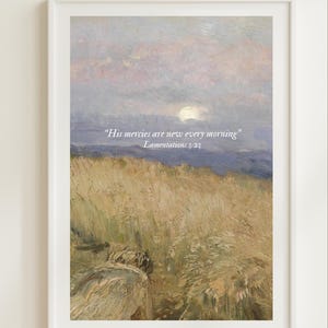 May include: Framed art print featuring a landscape painting with a field of tall, golden grass and a cloudy sky with a soft, pastel color palette. The text "His mercies are new every morning" Lamentations 3:23 is printed on the artwork.