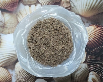 May include: A clear glass bowl filled with dried herbs, the herbs are a light brown color and have a fine texture.