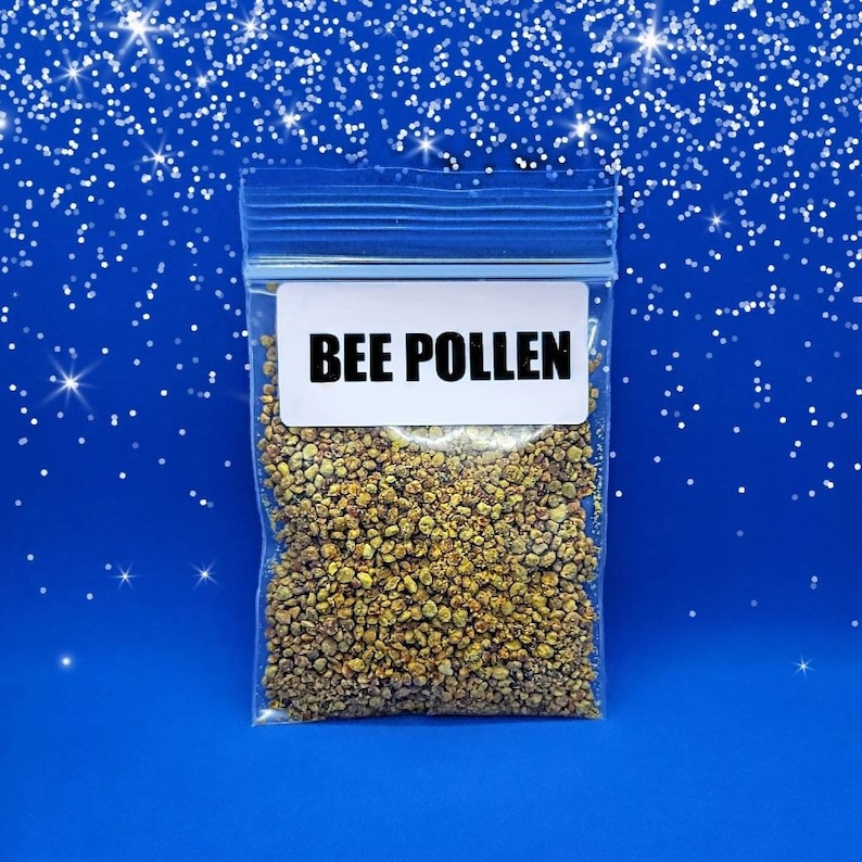 May include: A clear plastic bag with a white label that reads "BEE POLLEN". The bag contains a yellow and brown granular substance.
