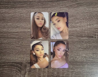 May include: Four photo cards featuring a woman with long brown hair and different outfits. The woman is wearing makeup and has a neutral expression. The cards are white with a black border.