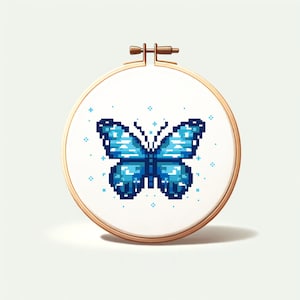 May include: A blue butterfly with white accents is embroidered on a white fabric stretched in a wooden embroidery hoop.
