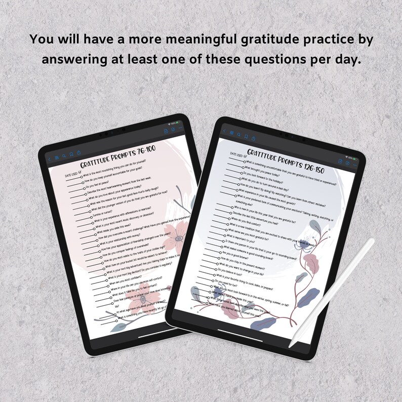 May include: Two digital tablets with floral designs on the screen. The tablets display a list of gratitude prompts, titled "Gratitude Prompts 76-100" and "Gratitude Prompts 126-150".