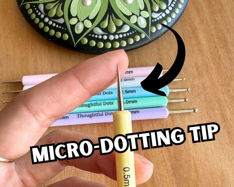 May include: A set of five dotting tools with different sized tips, ranging from 0.5mm to 2.5mm. The tools are made of metal and have a wooden handle. The tools are used for dotting art, such as mandala art.