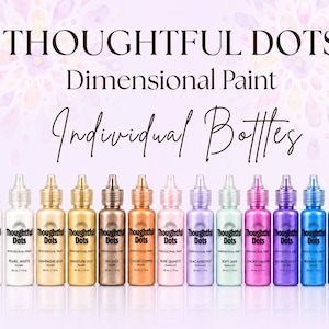 May include: A collection of twelve Thoughtful Dots dimensional paint bottles in various colors including white, gold, bronze, copper, pink, purple, green, and blue. Each bottle features a clear cap and a label with the product name and 1 fl oz volume.
