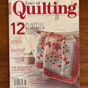 May include: A magazine cover titled "Love of Quilting" features a quilt with red, pink, and blue floral patterns. The cover also includes text about summer quilts and a trunk show.