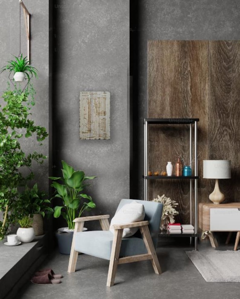 May include: A light blue armchair with a white cushion sits in a modern living room with a wooden shelving unit, a lamp, and a potted plant. The wall behind the chair is a light grey concrete.