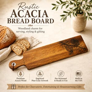 May include: A rectangular acacia wood bread board with a handle, featuring an engraved pine cone design. The board includes a metal ring with a leather cord. Text on the image reads: Rustic ACACIA BREAD BOARD, Woodland charm for serving, styling & gifting, Premium Acacia Wood, Engraved Pine Cone Artwork, Pre-Seasoned & Ready to Use, Made in the USA, Perfect for Charcuterie, Entertaining & Housewarming Gifts.