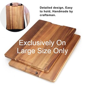 May include: Two wooden cutting boards, one on top of the other. The top board is larger and has a handle on each side. The bottom board is smaller and has a handle on one side. The boards are made of light brown wood and have a natural finish. The text "Exclusively On Large Size Only" is printed on the boards.