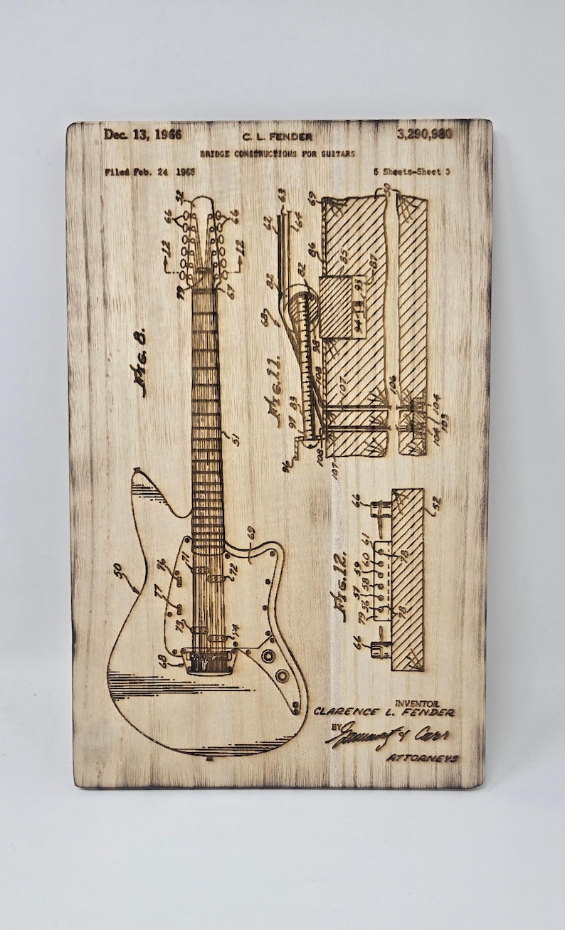 This beautiful wood engraving features a vintage schematic of a Fender guitar patent from 1966. The intricate laser-engraved details capture the craftsmanship and history of guitar design, making it a perfect piece for music lovers and collectors.