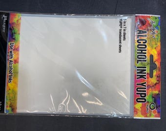 May include: A package of Ranger YUPO translucent sheets for alcohol inks. The package is labeled "5 in x 7 in sheets" and "Use with Alcohol Inks". The packaging has colorful accents and the words "ALCOHOL INK YUPO".