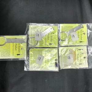 May include: Six individually packaged metal socket wrenches, each with a different size. The packaging is white with a yellow label that reads "The Socket Pocket".
